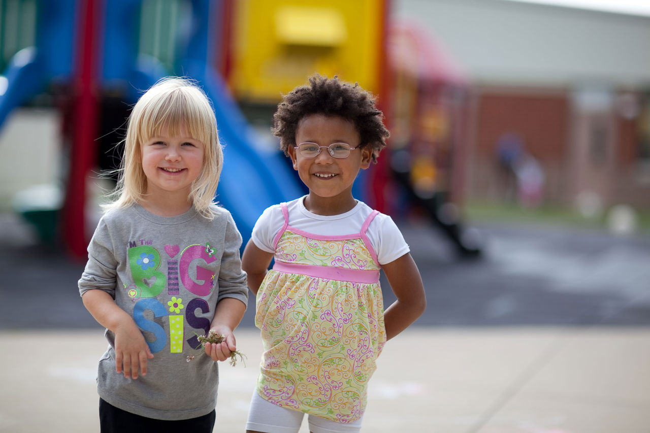 Two girls smiling on playground