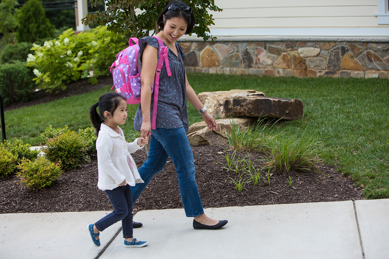 Mother dropping off daughter at preschool